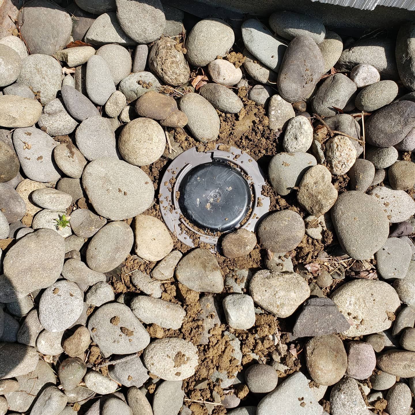 A pile of rocks with a metal object in the middle