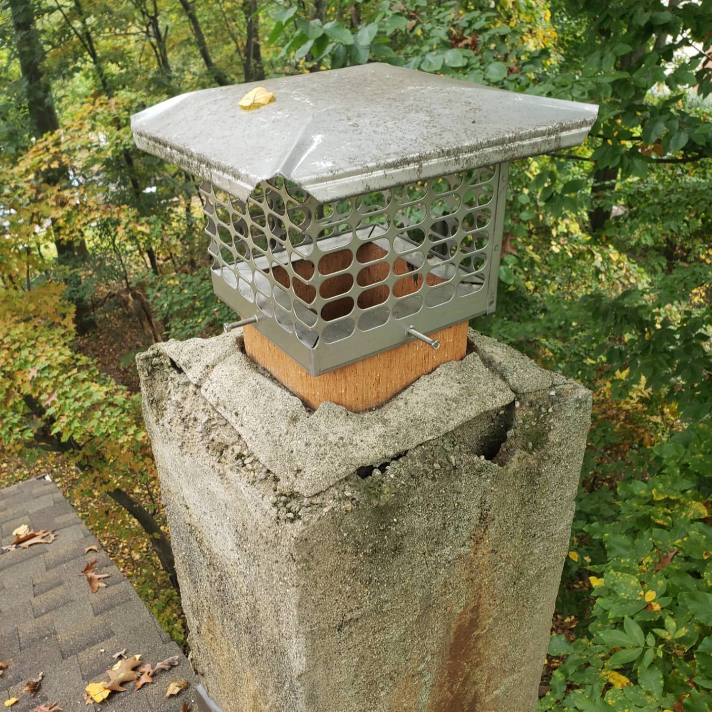 A chimney with a metal cage on top of it