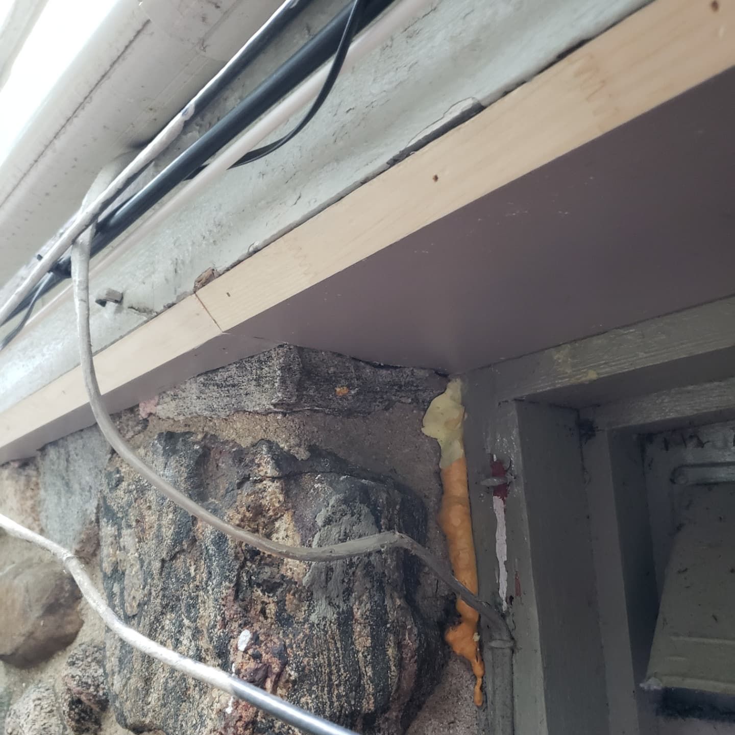 A wall with a few wires hanging from it