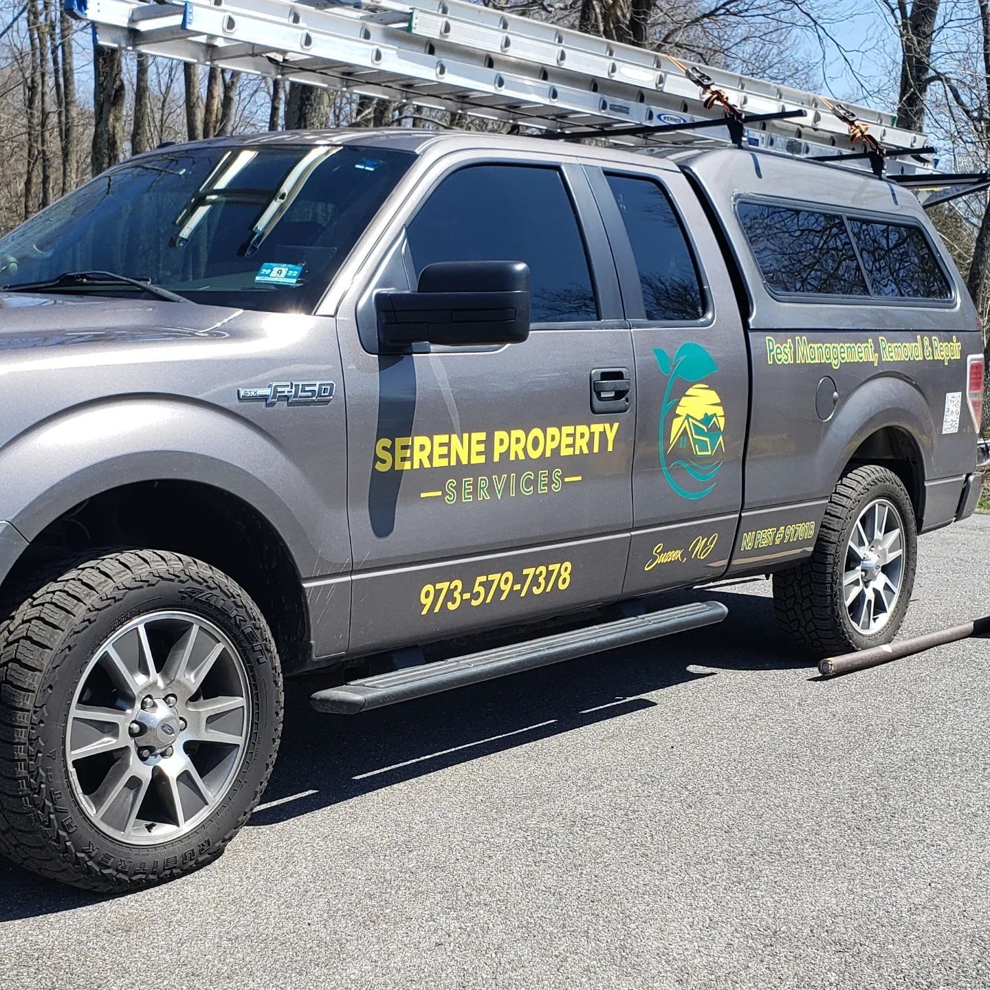 A serene property truck is parked on the side of the road.
