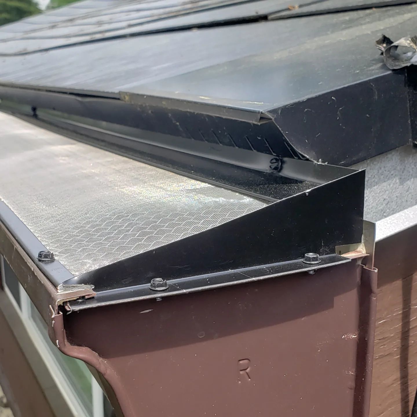 A close up of a metal gutter on a roof
