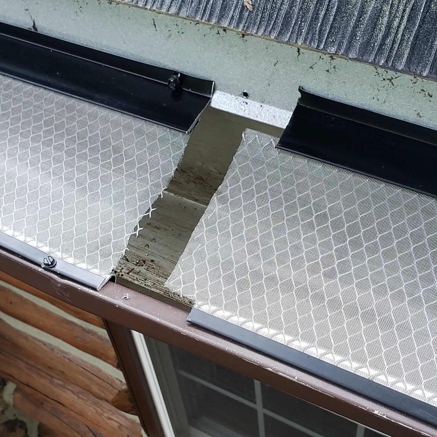 A close up of a gutter with a hole in it