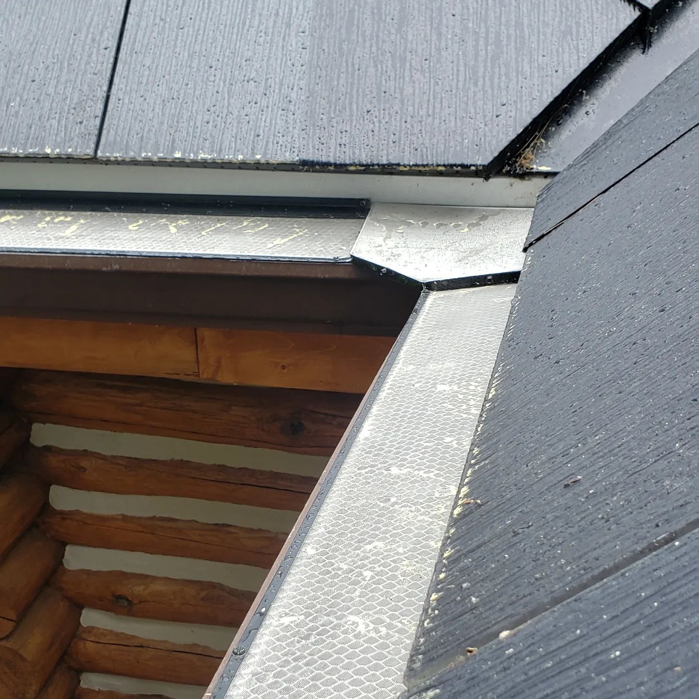 A close up of a roof with a gutter on it