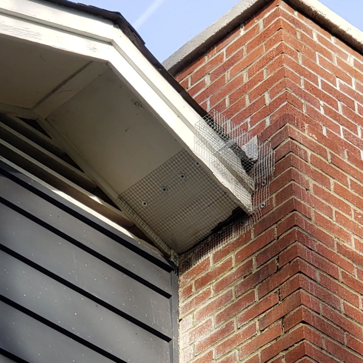 A brick chimney on the side of a house
