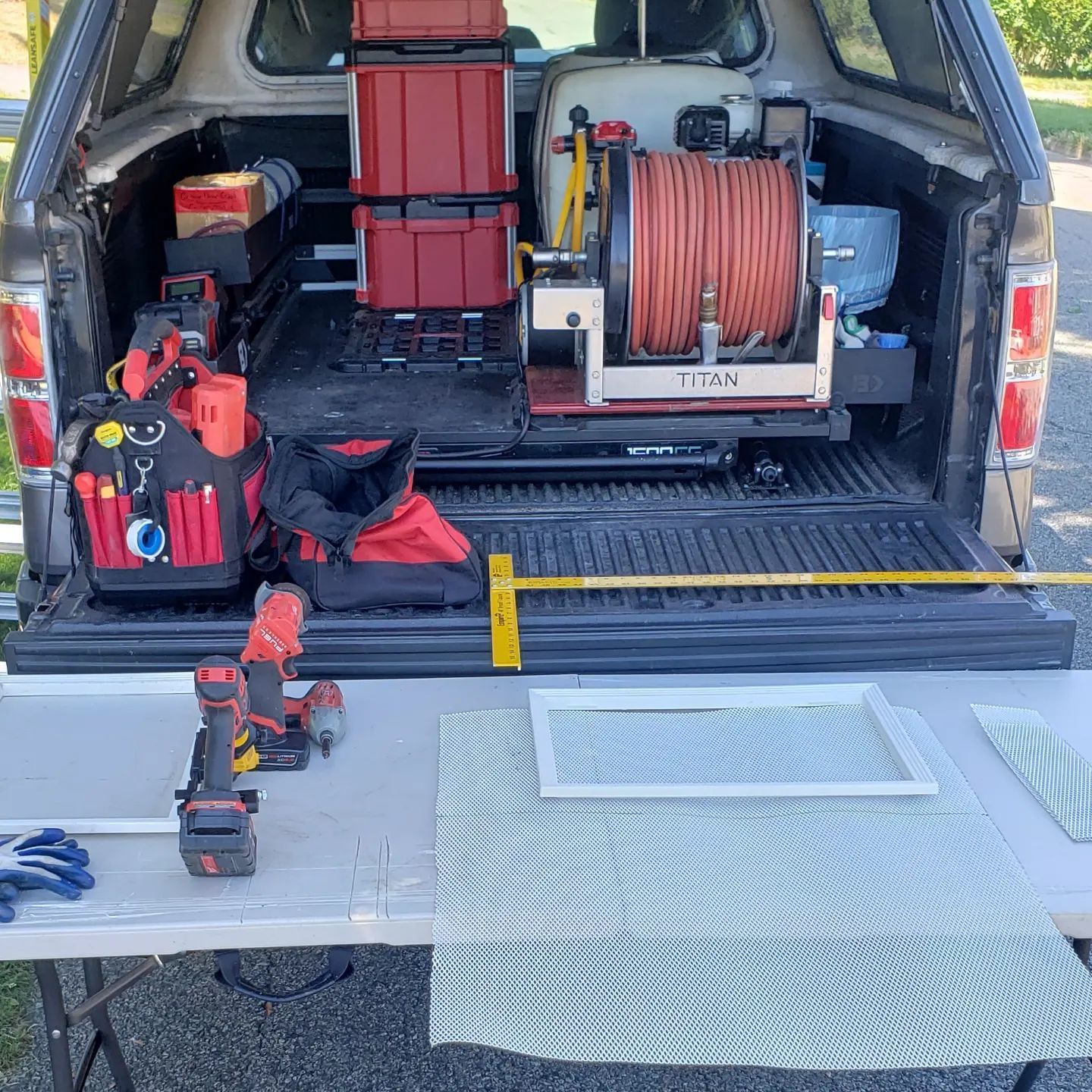 The back of a truck is filled with tools and equipment.