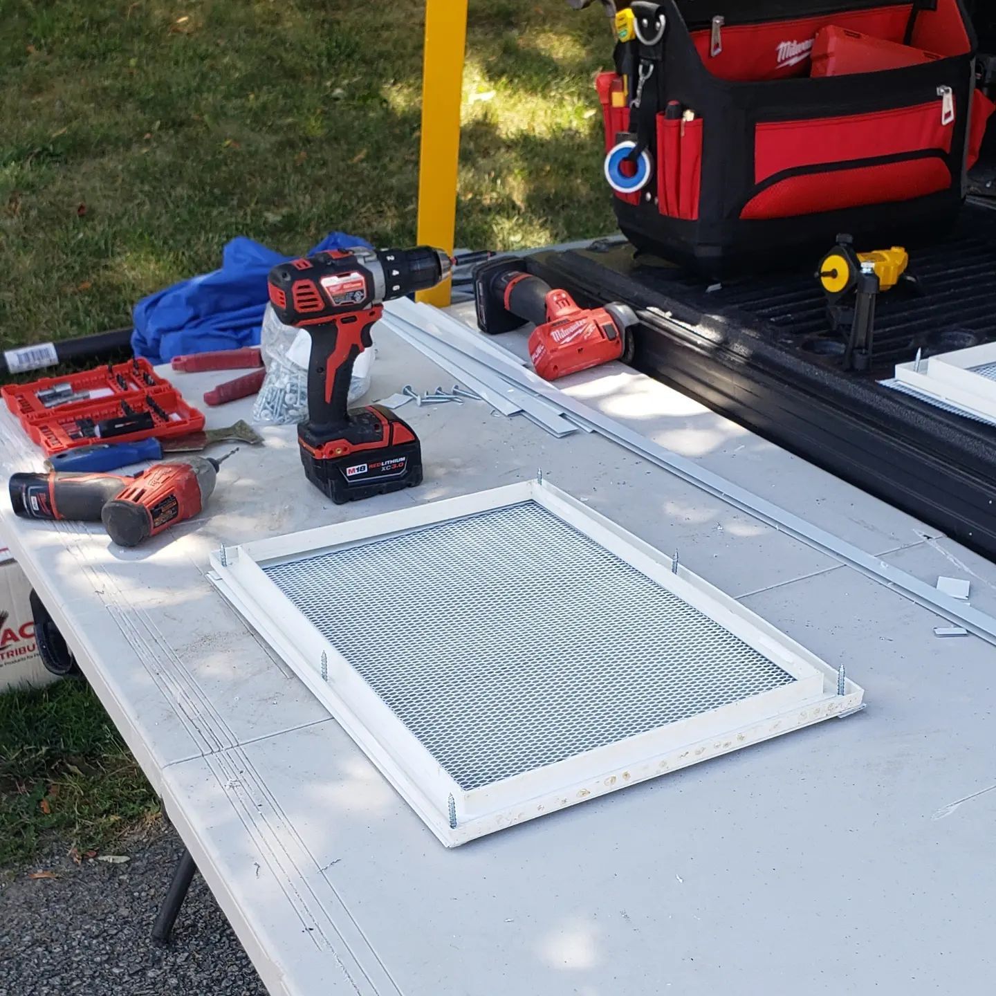 A table with tools and a drill on it