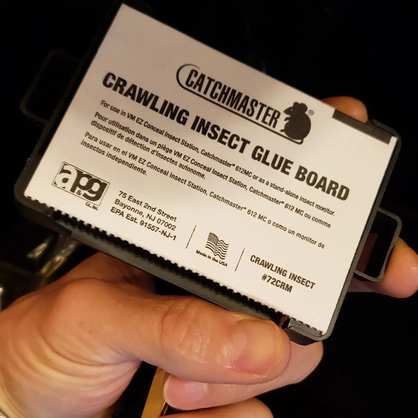 A person is holding a crawling insect glue board