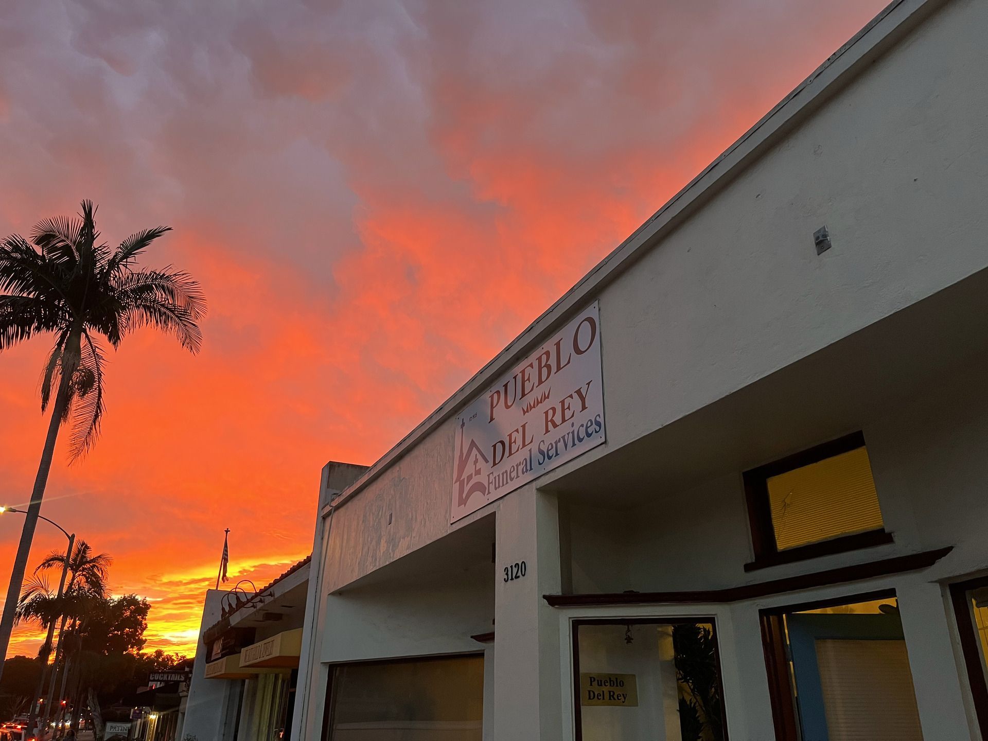 Sunset over a white building with 
