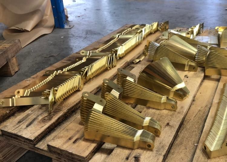 A bunch of brass pieces cut by Hygrade Laser.