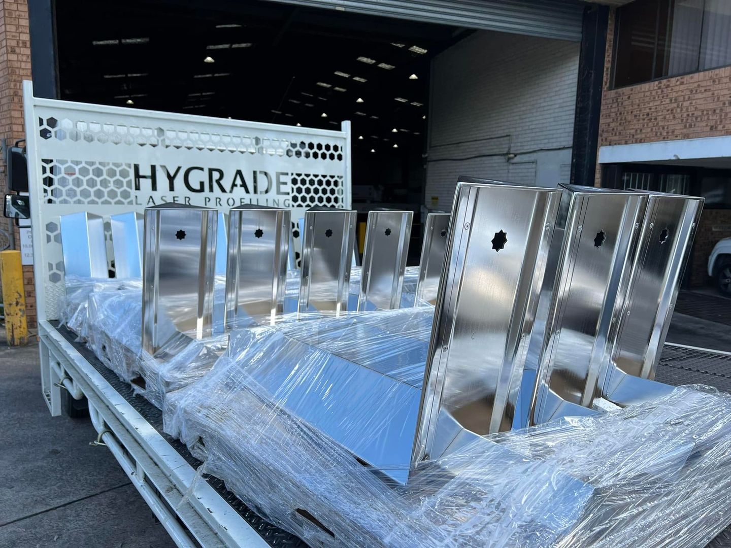 A truck with a bunch of stainless steel pieces on it, which are cut by Hygrade Laser.