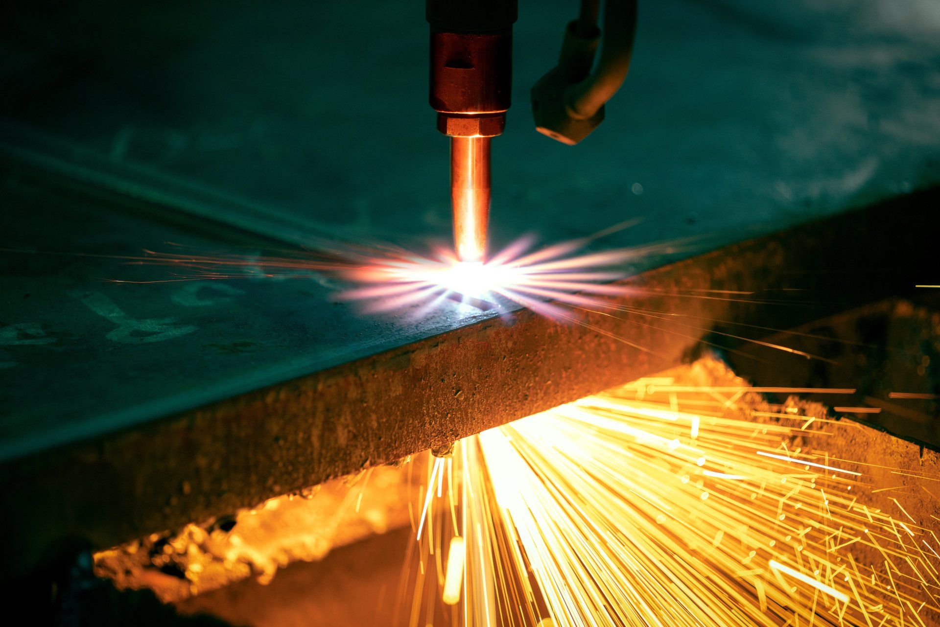 a plasma cutter cutting a thick sheet of metal