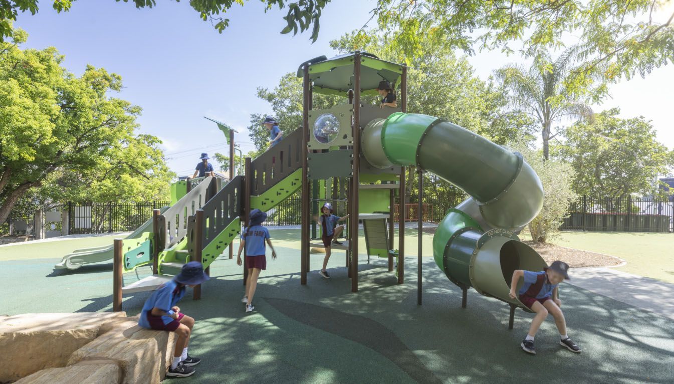 A wooden bench under a wooden umbrella in a park.