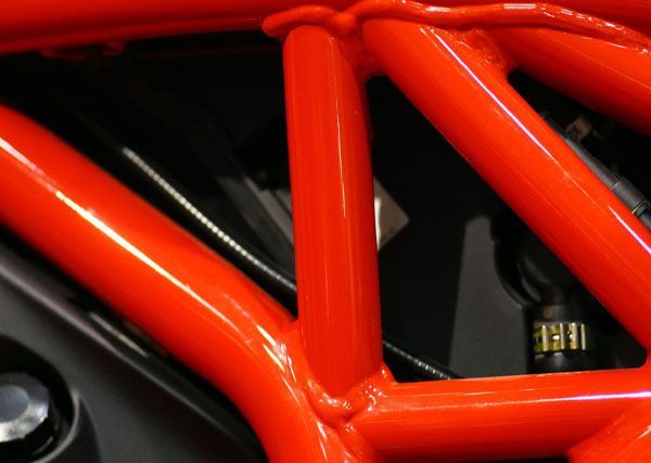 A close up of a red motorcycle frame.