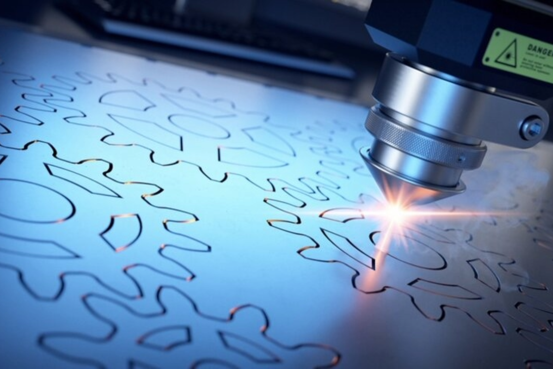 Laser cutting metal sheet with bright sparks in a manufacturing machine
