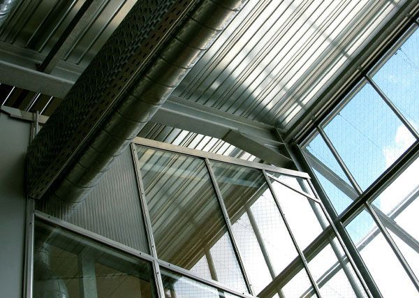Looking up at the ceiling of a building with lots of windows