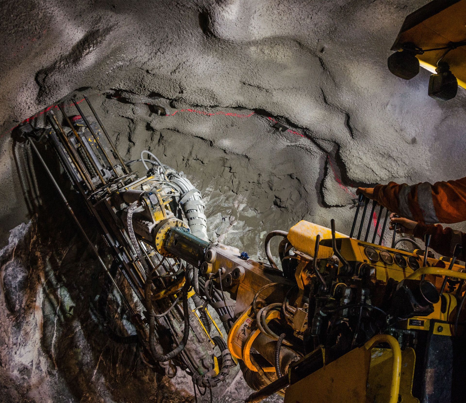 A man is working on a machine in a tunnel.