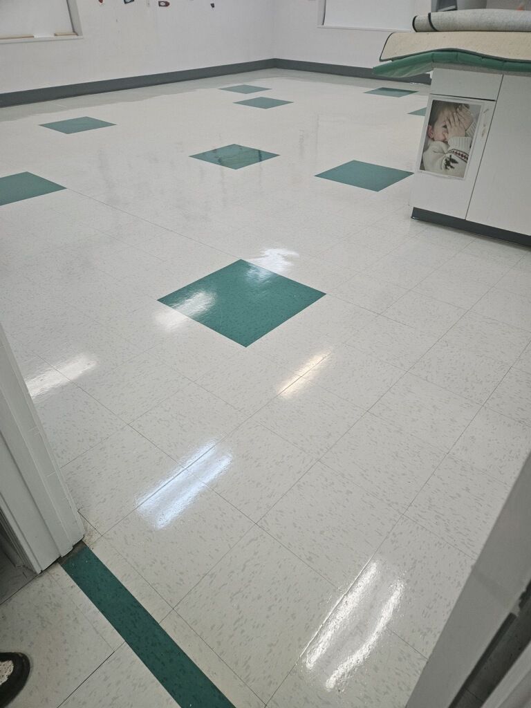 A room with a white floor and green squares on it.