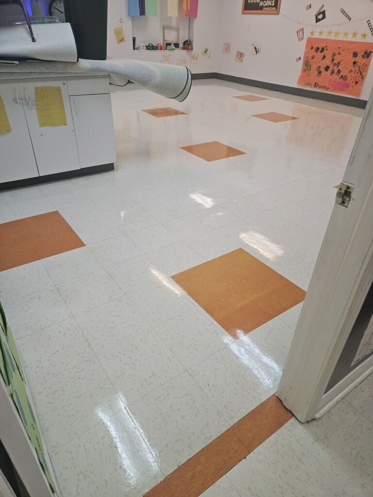 A white and orange tiled floor in a room with a door.