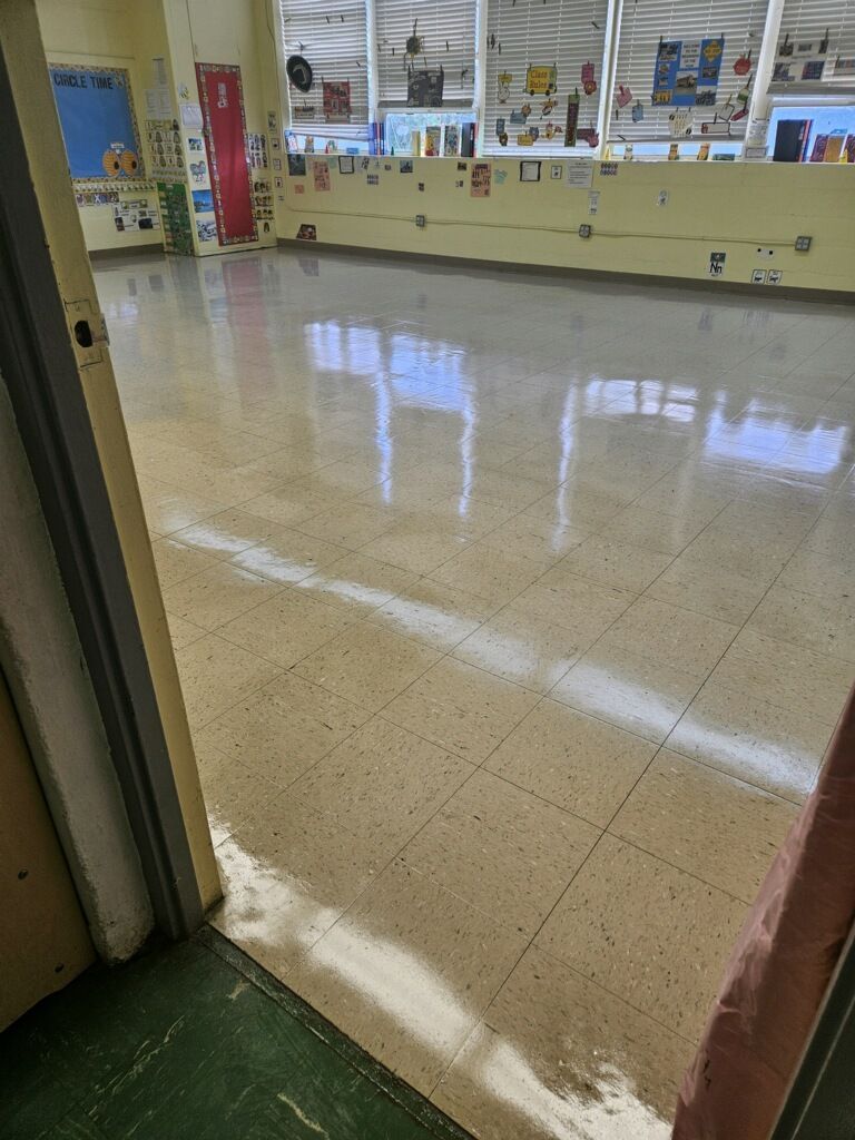 A large room with a tiled floor and a doorway leading to it.