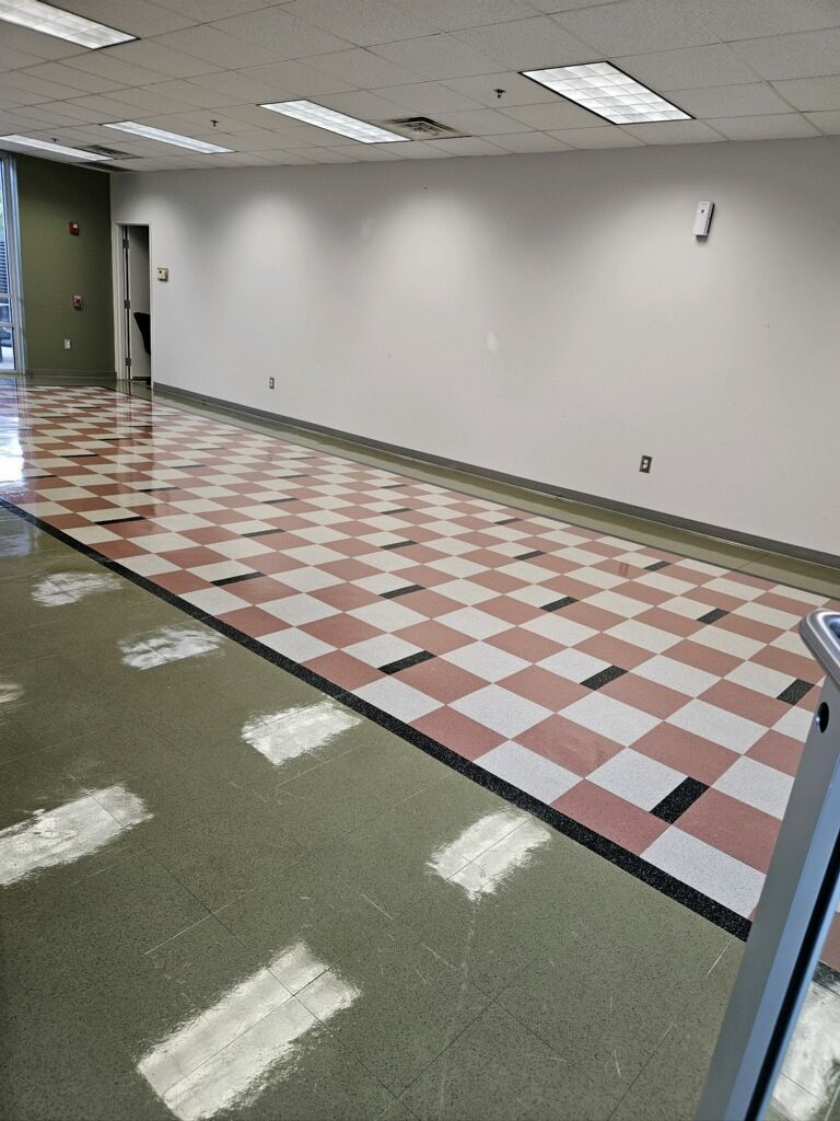 An empty room with a checkered floor and white walls.