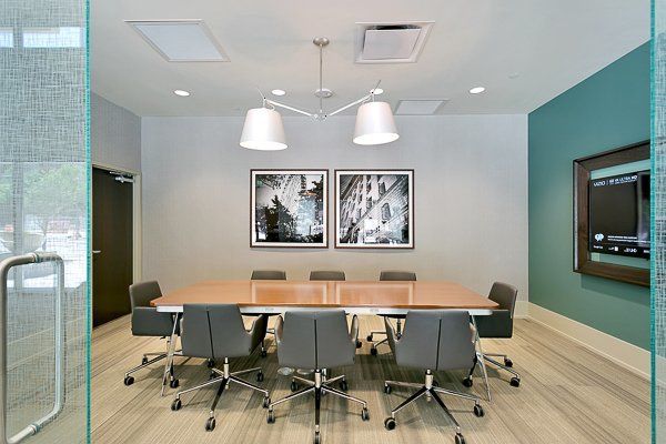 A conference room with a long table and chairs