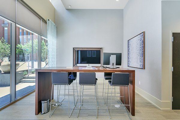 A room with a table and chairs and a computer on it