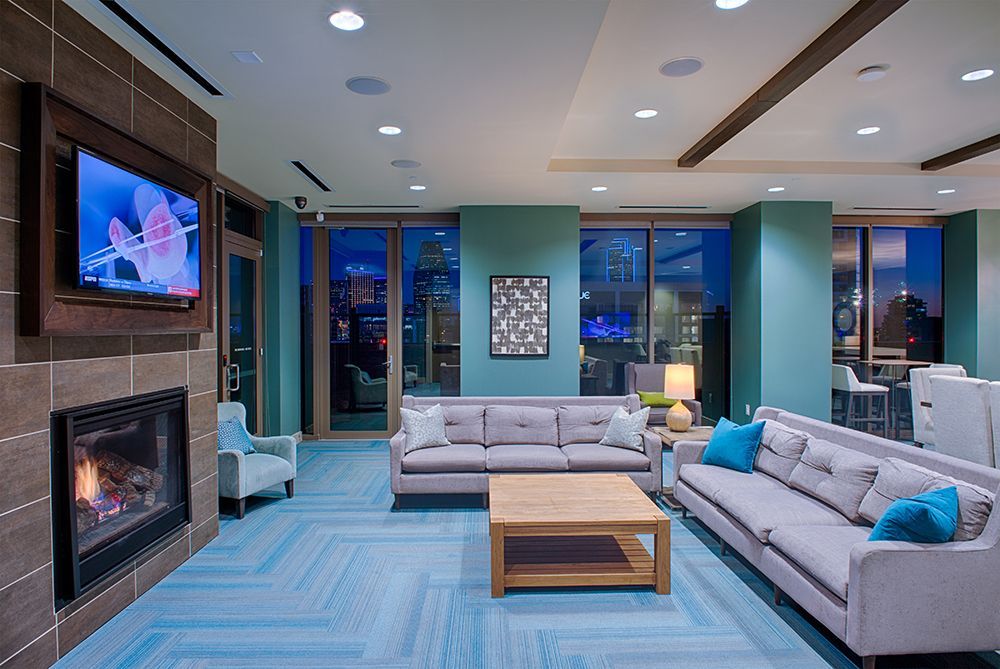 Clubhouse filled with furniture and a fireplace.