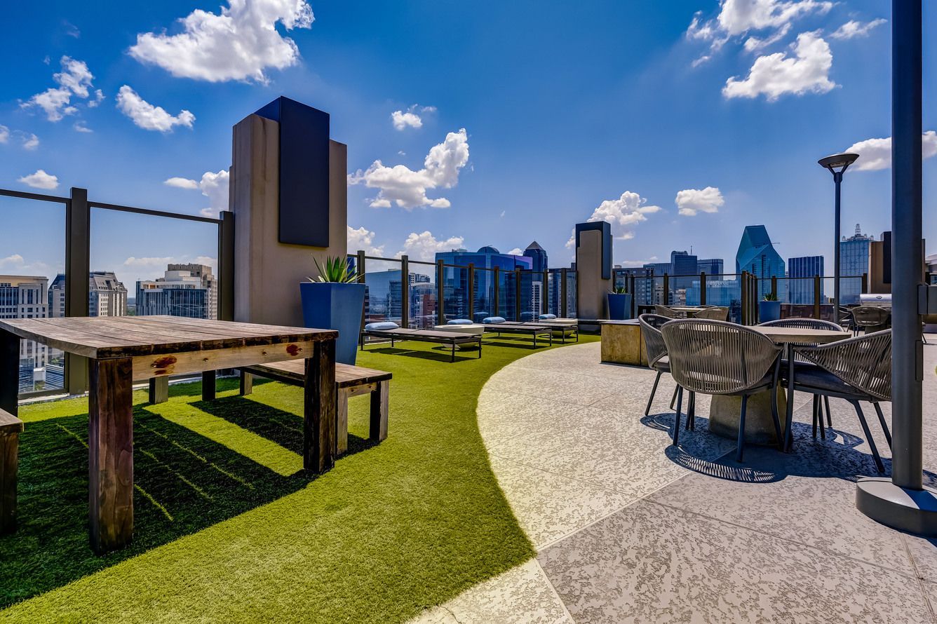 There is a table and chairs on the roof of a building.