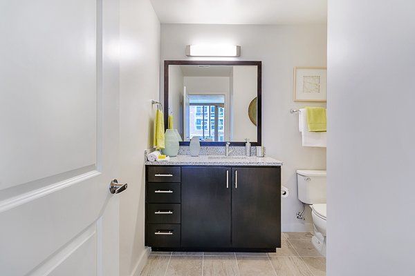 A bathroom with a sink , toilet and mirror.