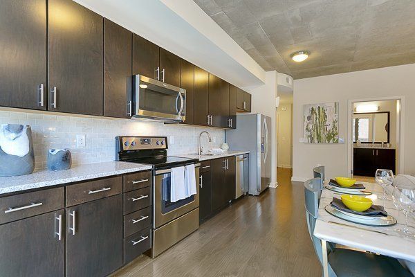 A kitchen with stainless steel appliances and wooden cabinets