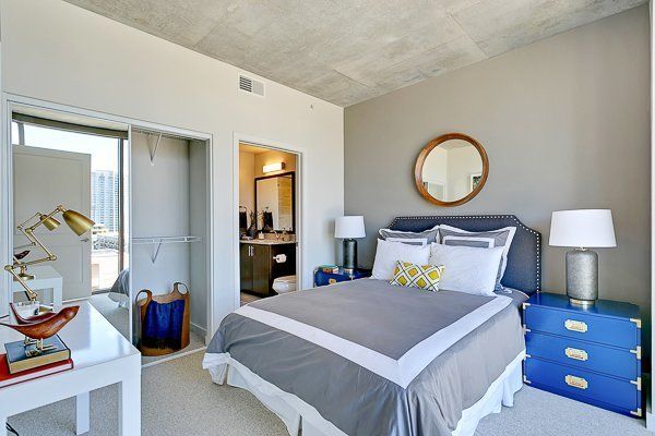 A bedroom with a large bed and a blue nightstand