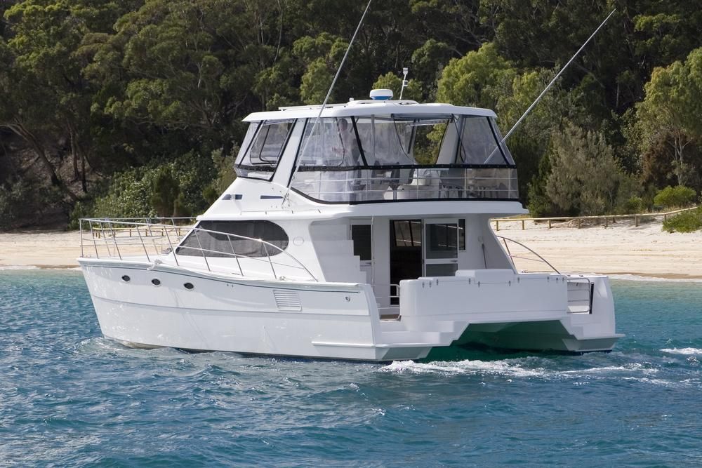 A White Boat Is Floating On Top Of A Body Of Water — PASMA Electrical In Weipa, QLD