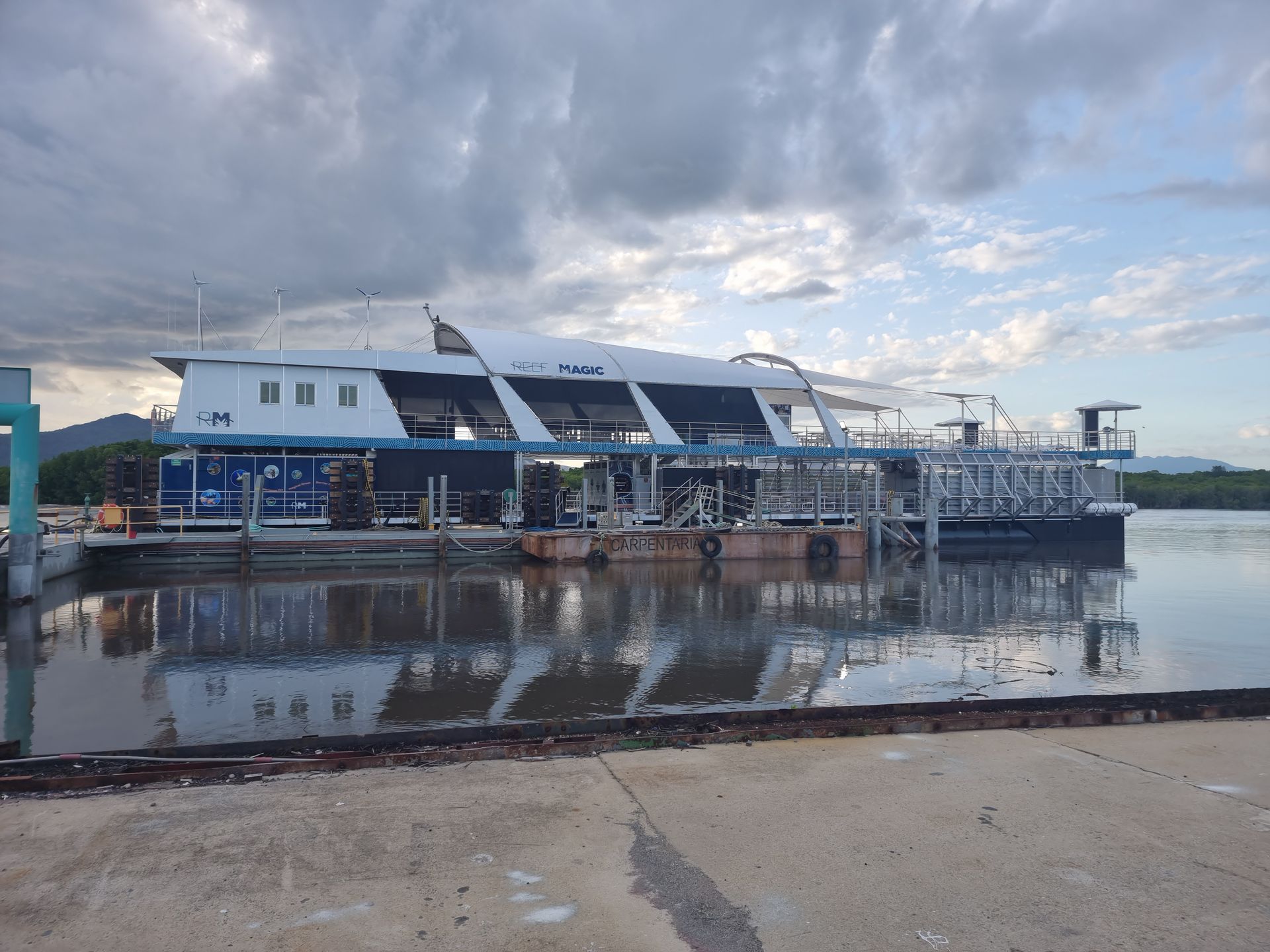 A Large Boat Is Docked At A Dock In The Water — PASMA Electrical In Portsmith, QLD