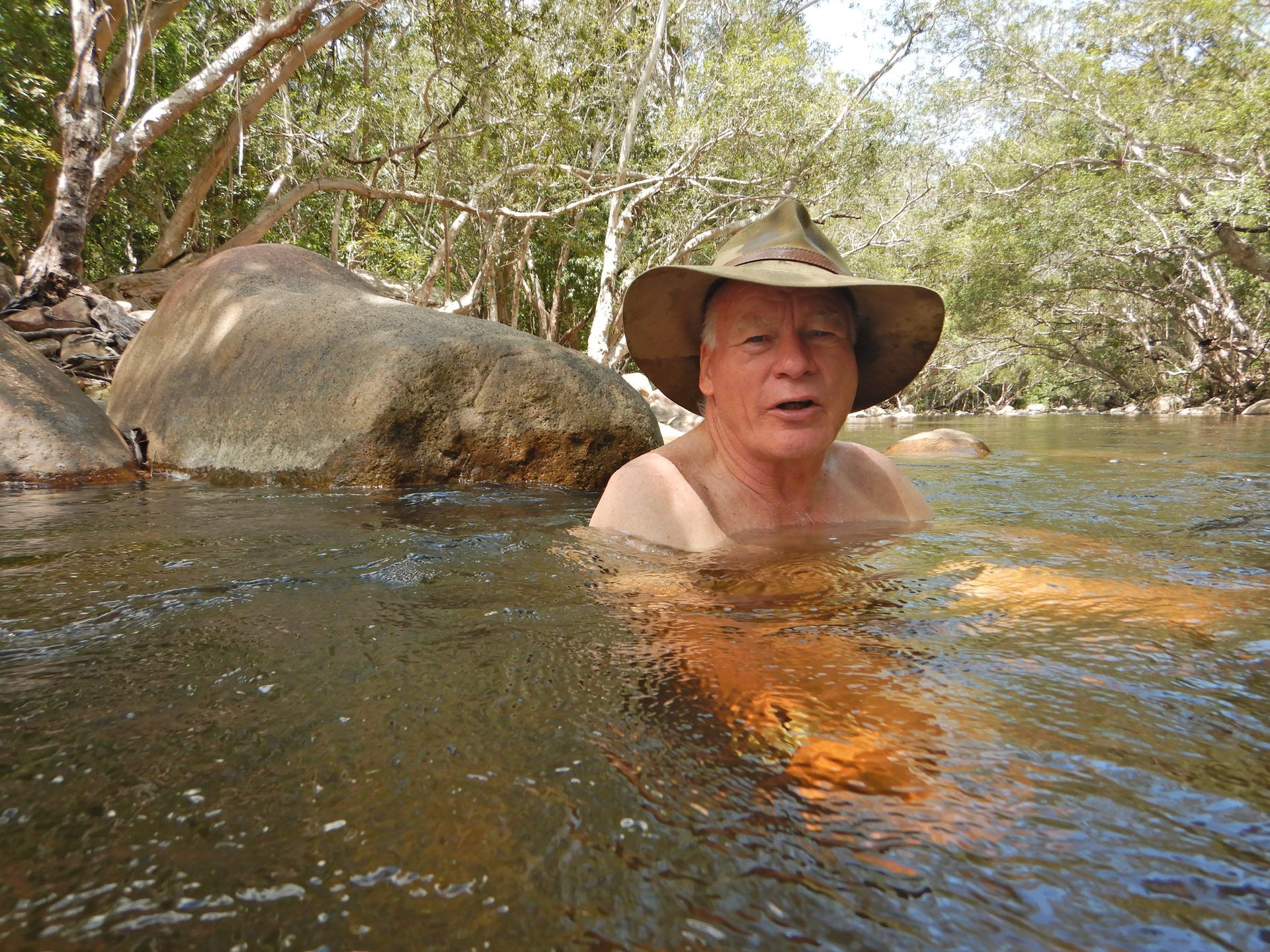 A Man In A Cowboy Hat Is Swimming In A River — PASMA Electrical In Portsmith, QLD