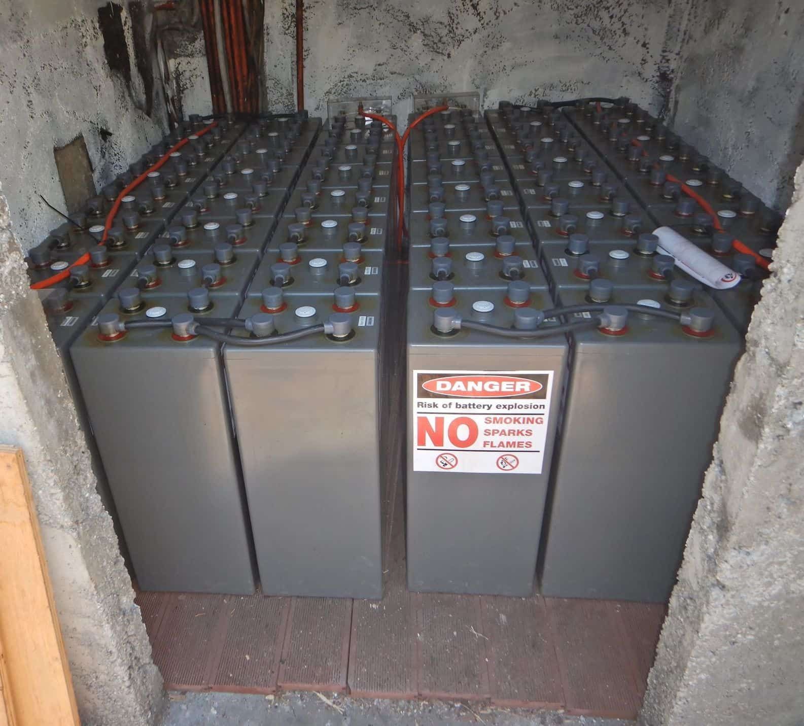 Two Batteries In A Room With A Sign That Says Danger No — PASMA Electrical In Portsmith, QLD