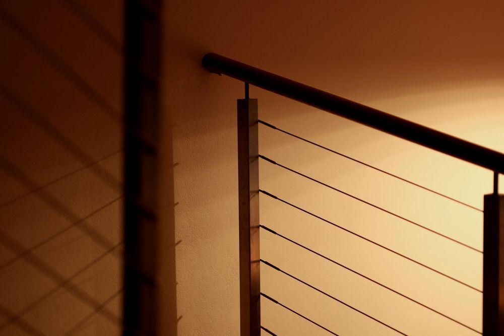 A Staircase With a Stainless Steel Railing and a Wooden Handrail — Mackay Hardwood Sales in Moranbah, QLD