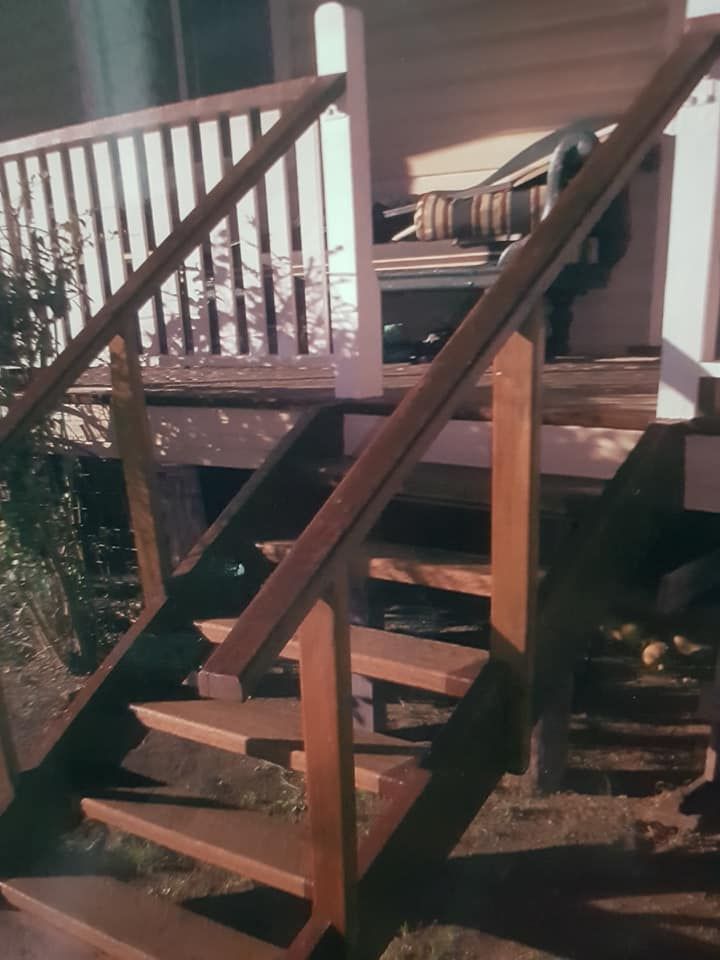 A Wooden Staircase Leading Up to a Deck With a White Railing — Mackay Hardwood Sales in Freshwater Point, QLD