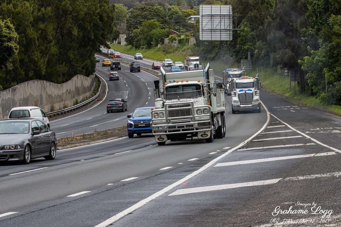 A Truck Is Driving Down A Highway Next To Cars — JMAK Haulage & Landscapes Supplies In Vincentia, NSW