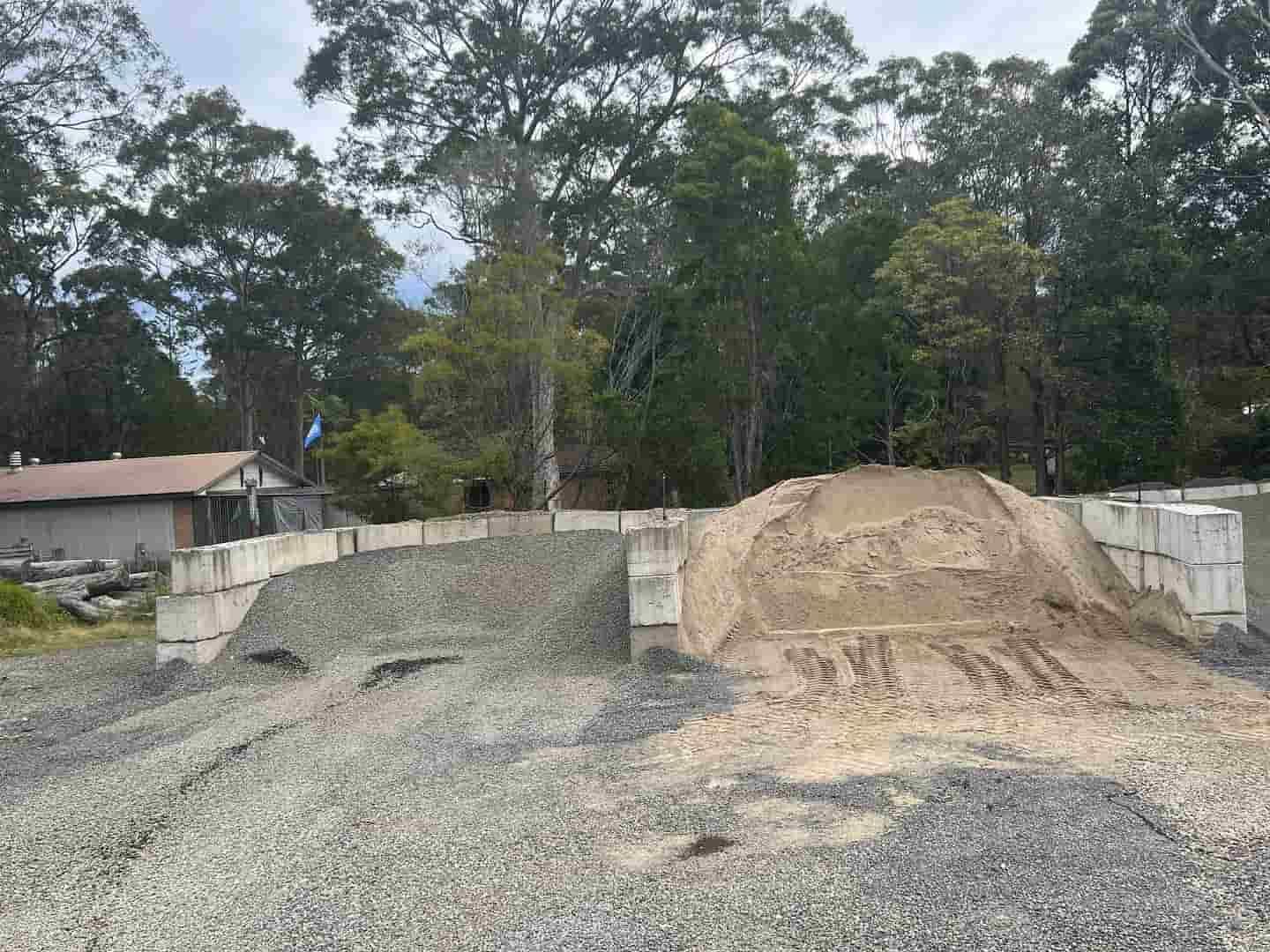 A Pile Of Gravel Is Sitting On Top Of A Dirt Field  — JMAK Haulage & Landscapes Supplies In Falls Creek, NSW