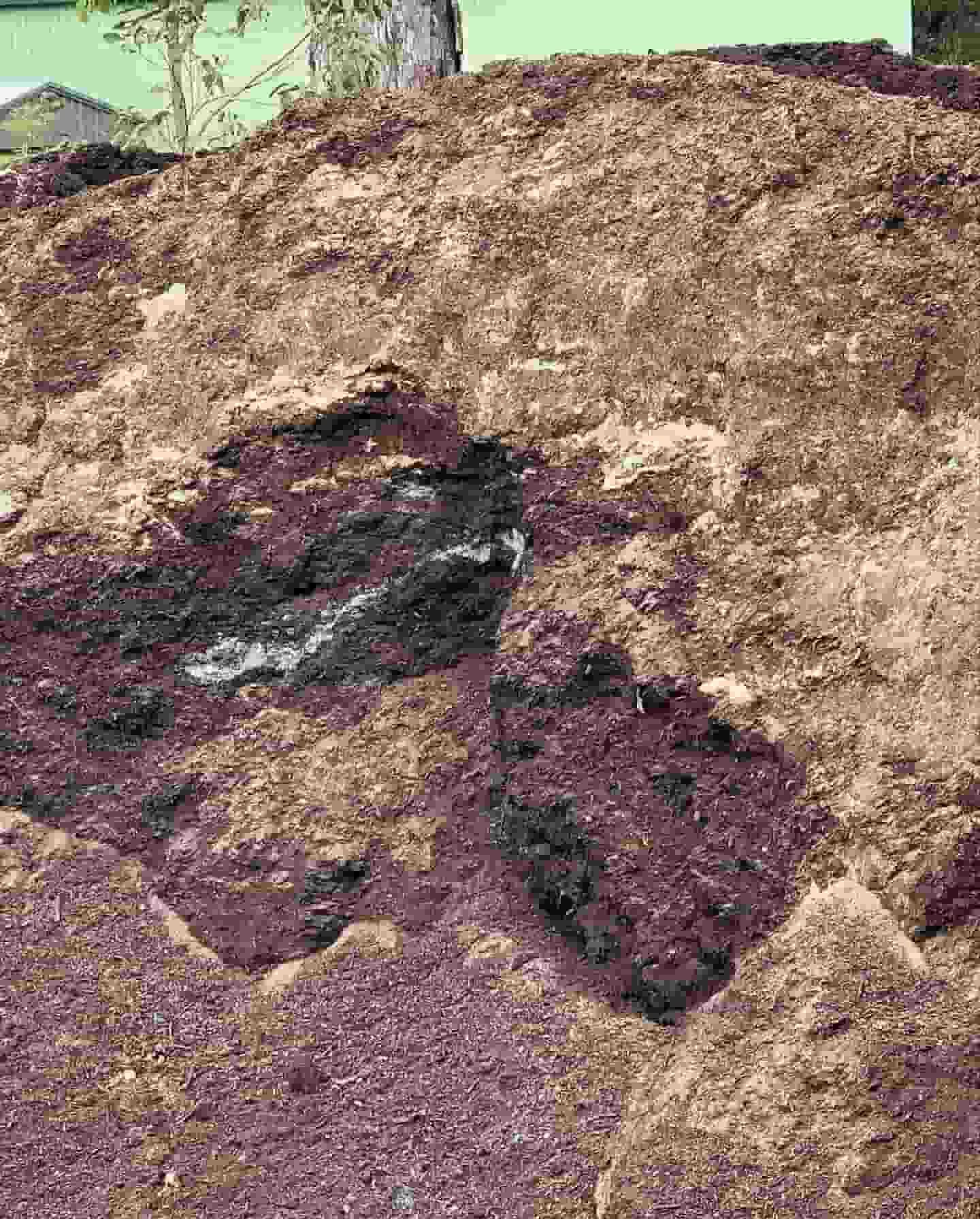 A Pile Of Dirt With A Hole In The Middle Of It — JMAK Haulage & Landscapes Supplies In Falls Creek, NSW