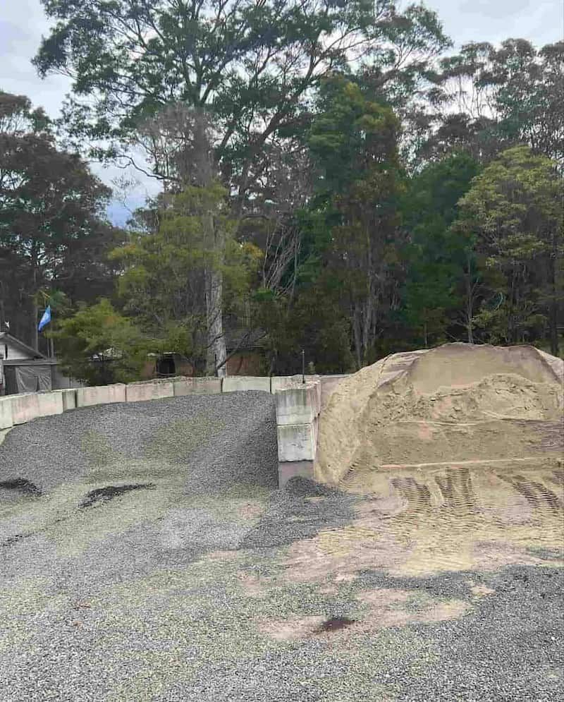 A Pile Of Gravel Is Sitting In The Middle Of A Forest — JMAK Haulage & Landscapes Supplies In Falls Creek, NSW