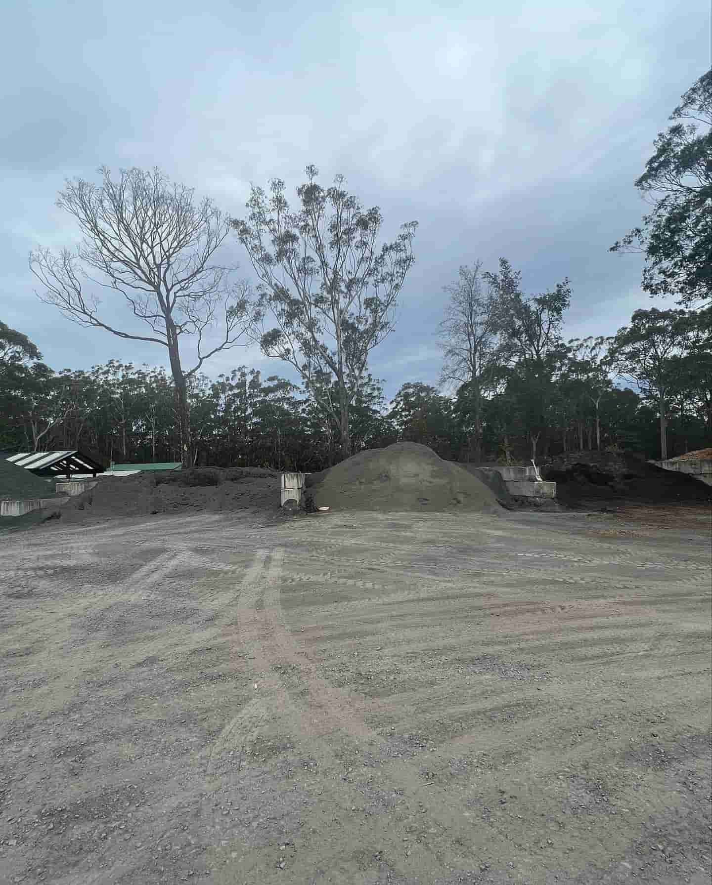 A Dirt Road With Trees In The Background And A Pile Of Dirt In The Middle — JMAK Haulage & Landscapes Supplies In Berry, NSW