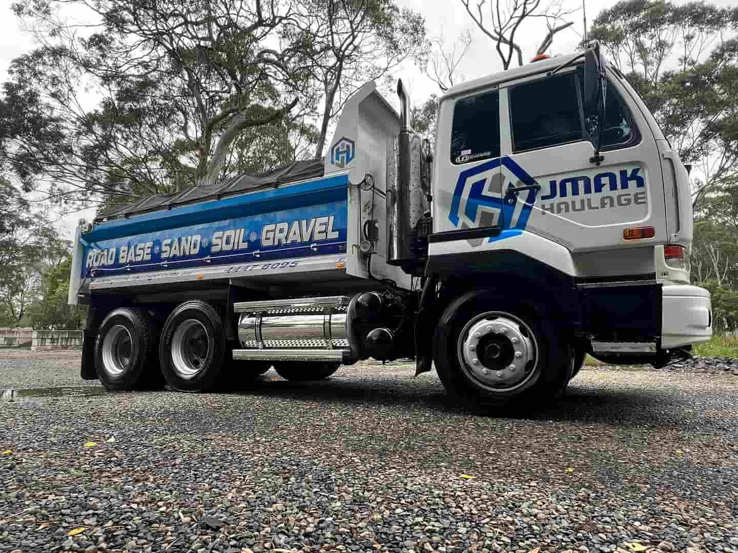 A Dump Truck Is Parked On A Gravel Road — JMAK Haulage & Landscapes Supplies In Falls Creek, NSW