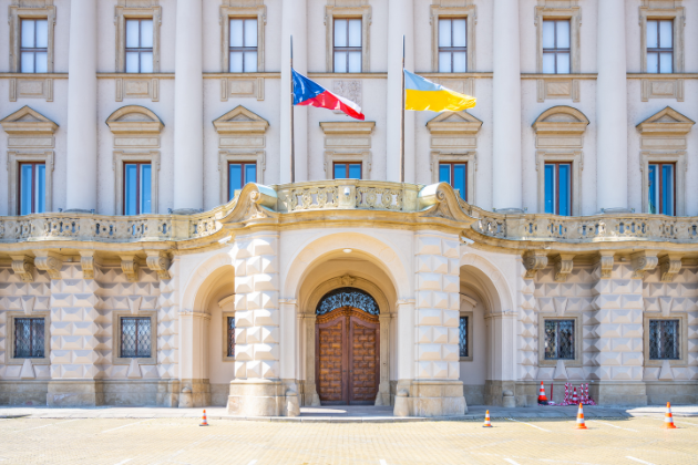 a large building with two flags flying in front of it .