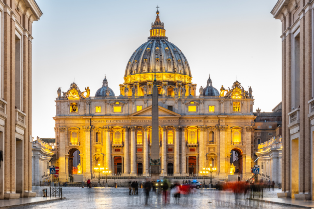 a large building with a dome on top of it is lit up at night .