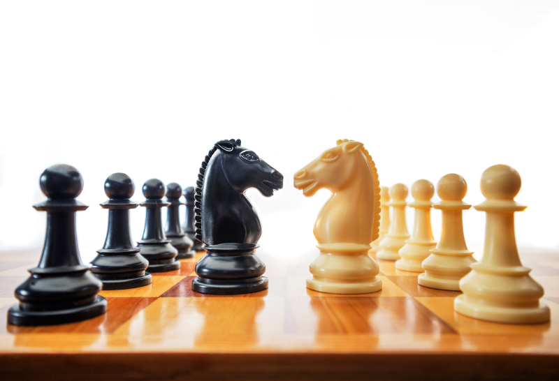 a chess board with black and white chess pieces on it
