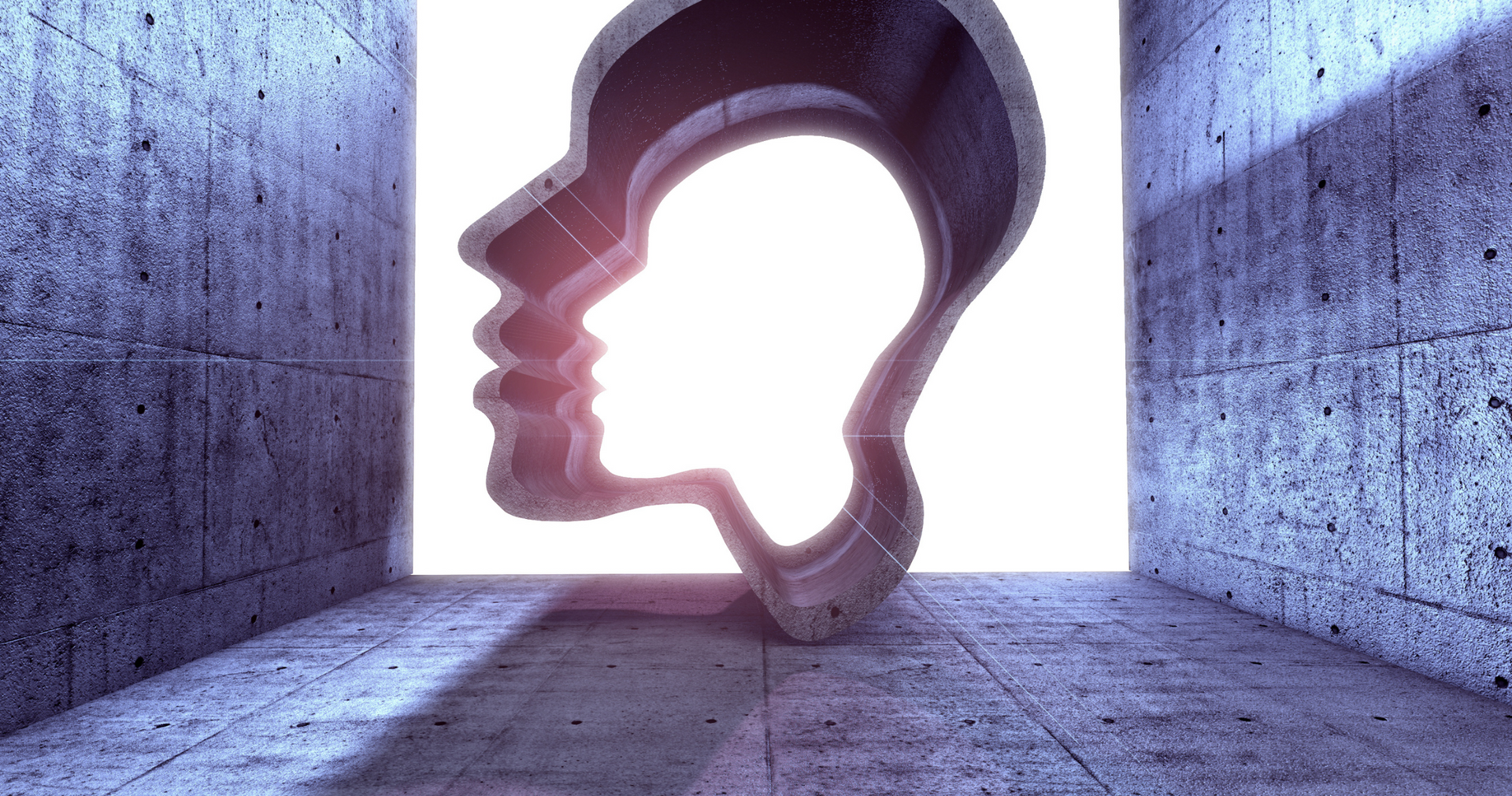 a statue of a man 's head is in a concrete room .