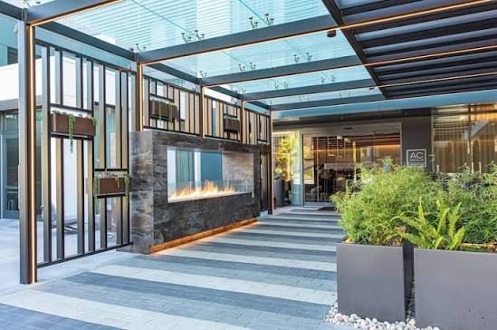 Steel roof truss framework against a blue sky. Construction site.
