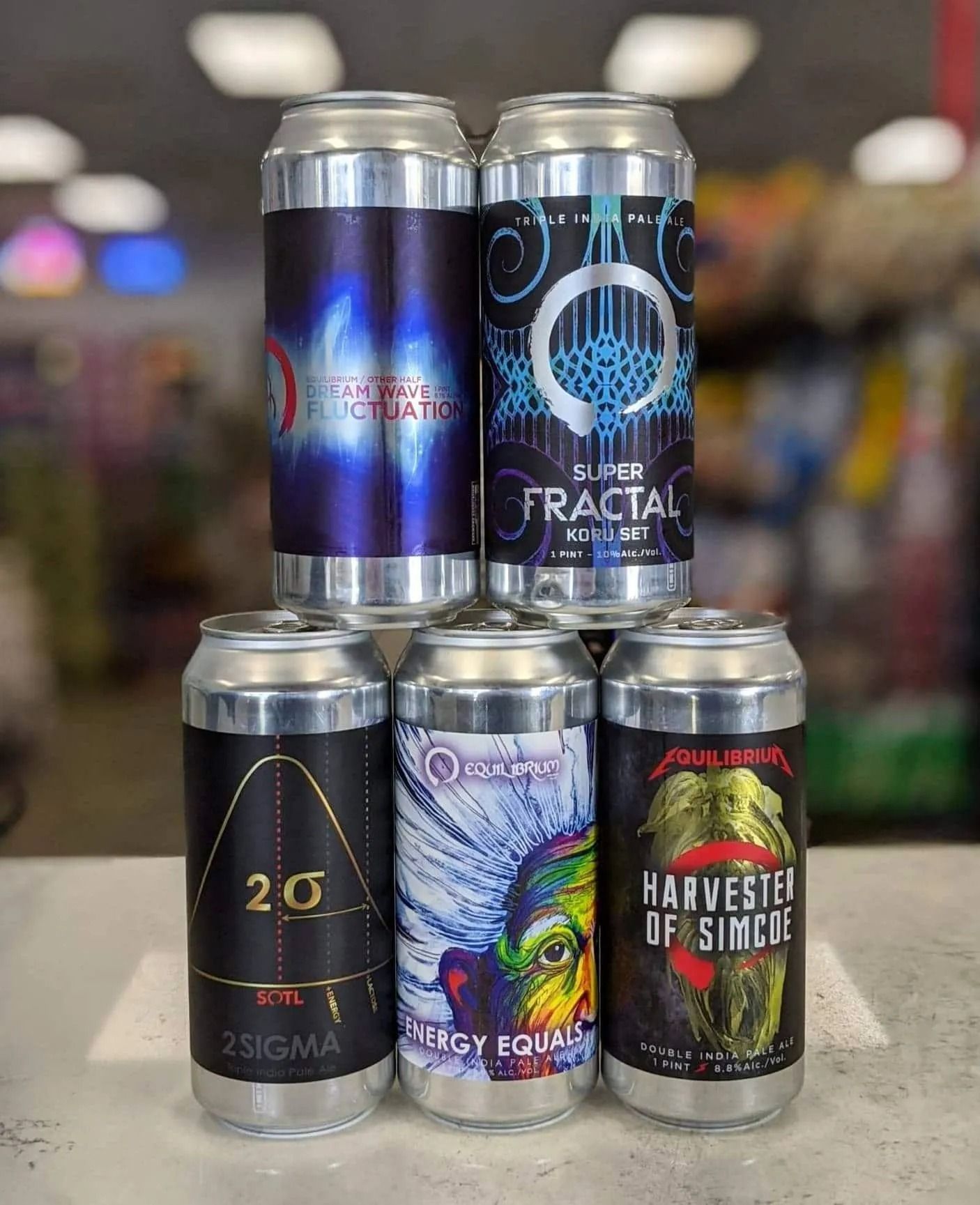 Stack of beer cans with colorful labels: 