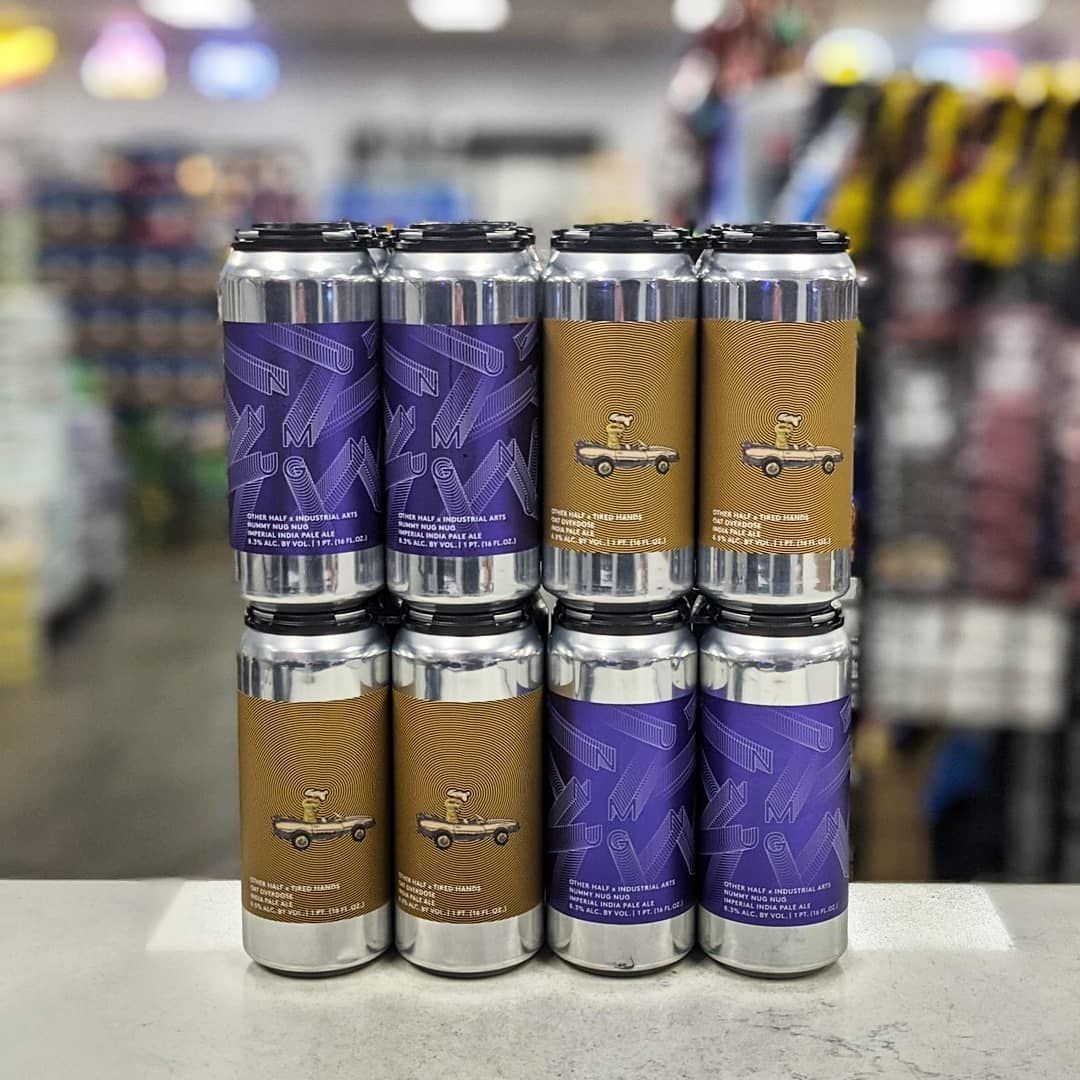 Eight beer cans stacked, alternating between purple and tan with a car design.